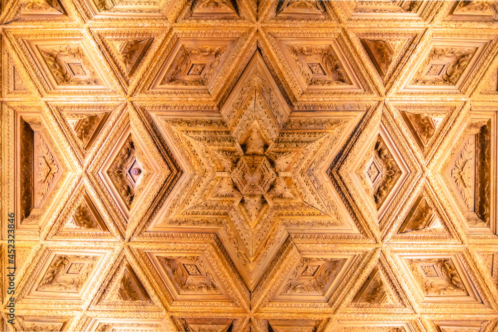 Obraz premium View of the ceiling of a chapel carved in wood with geometric shapes of the interior of the old religious cathedral of Cuenca at sunset, World Heritage City, Spain.