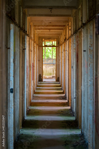 crumbling creepy abandoned corridor with pockets of light