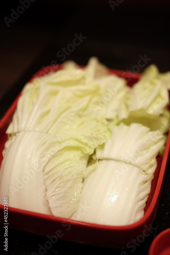 Fresh lettuce sliced on red square plate