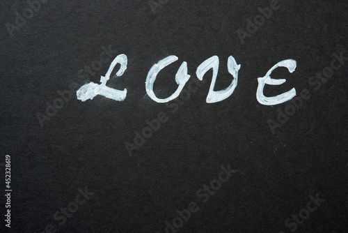 the word "love" stencilled in white on black paper