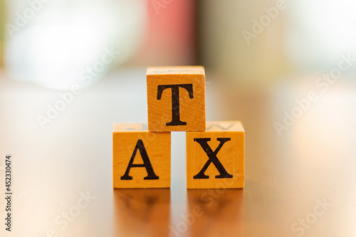 The word Tax and blur background,The word on wood square cubes,Concept word cubes, Wooden box