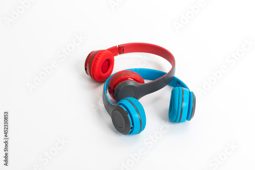 two red and blue headphones over white background. Music concept.