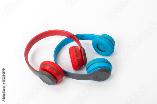two red and blue headphones over white background. Music concept.