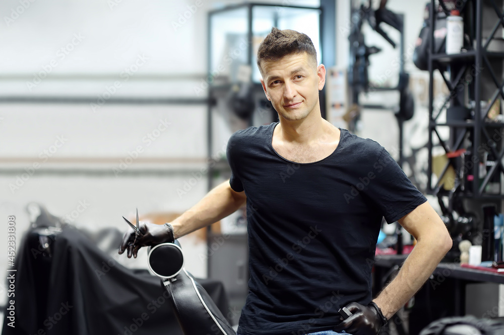 Handsome barber master in salon. Hair artist in man barbershop. Services of professional hair stylist. Fashion haircare for men. Handsome barber master in salon. Hair artist in man barbershop. Services of professional hair stylist. Fashion haircare for men.