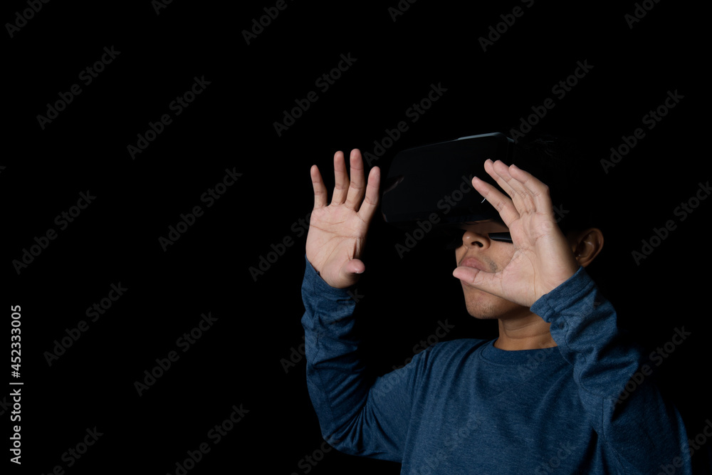 Young man using virtual reality headset. VR, future, technology online concept. black background. Young man using virtual reality headset. VR, future, technology online concept. black background.