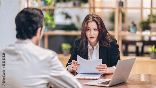serious  female lawyer meeting customer to legal document at desk