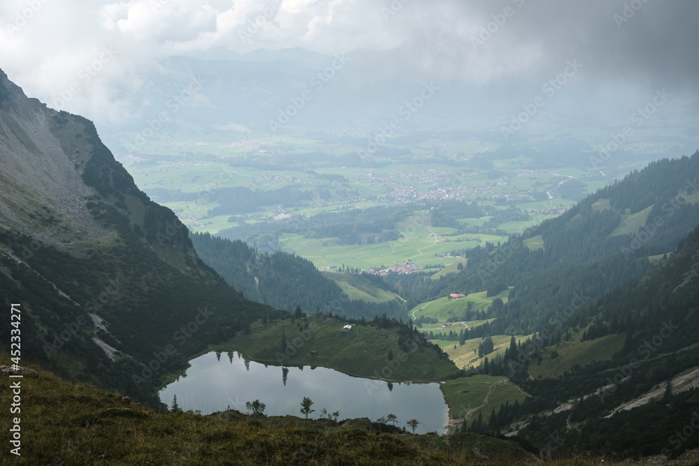 View from the mountain to the lake Gaisalp in the foreground and the mountain Rubihorn at the left in Allgäu Germany.