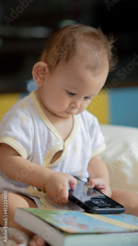 Modern Day Social Issue, Young Baby girl is trying to play on a smartphone