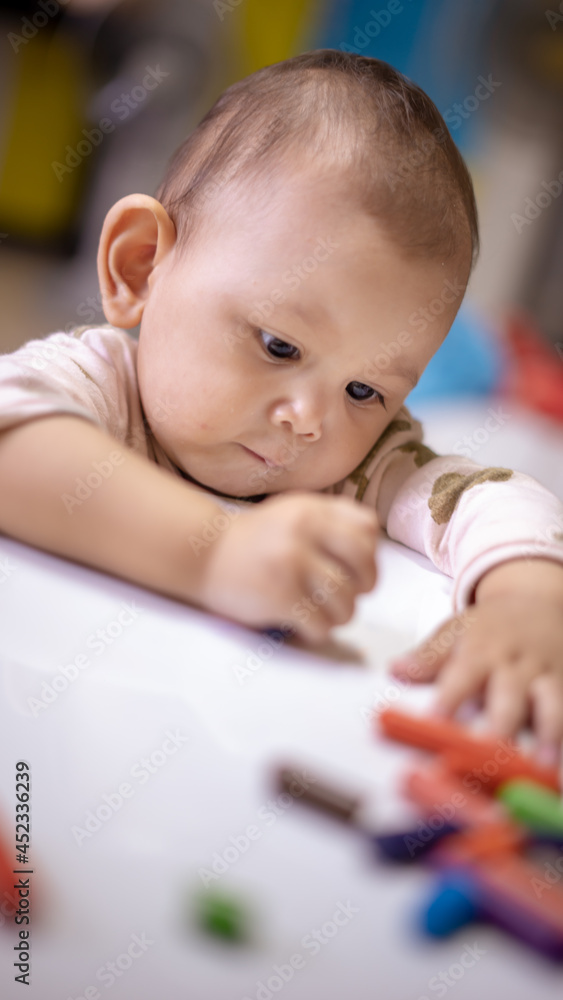 Baby Asian Girl drawing and playing as she develops her motor skills Baby Asian Girl drawing and playing as she develops her motor skills