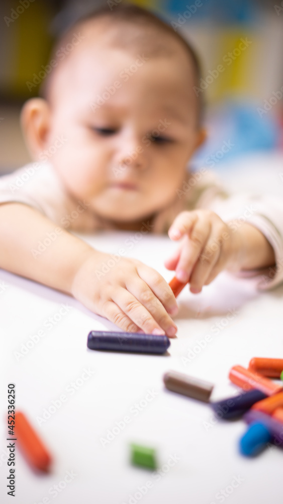 Baby Asian Girl drawing and playing as she develops her motor skills Baby Asian Girl drawing and playing as she develops her motor skills