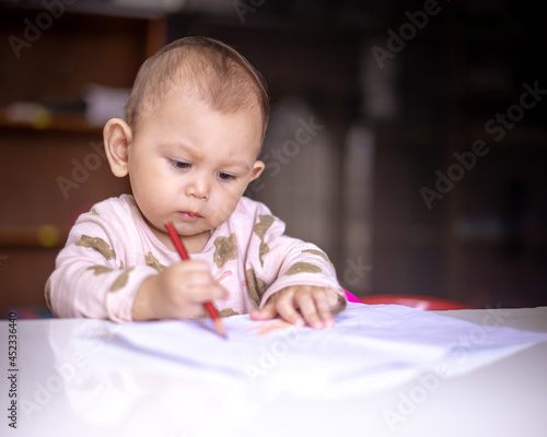Baby Asian Girl drawing and playing as she develops her motor skills