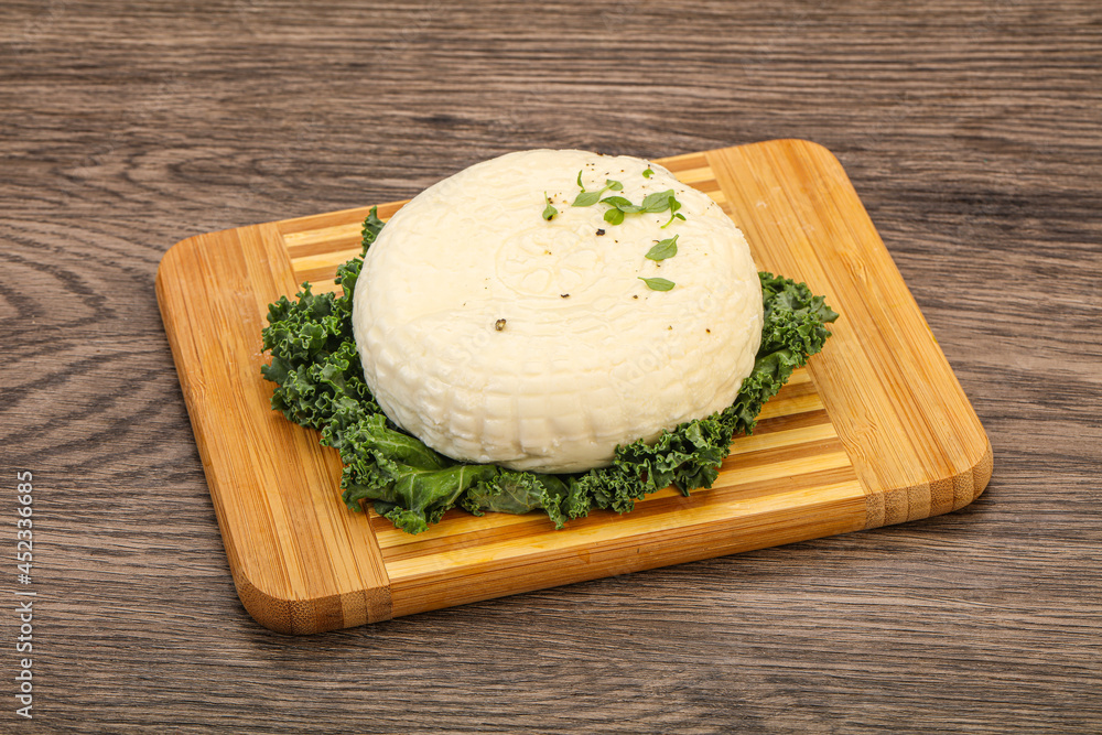 Caucasian suluguni round cheese piece Caucasian suluguni round cheese piece