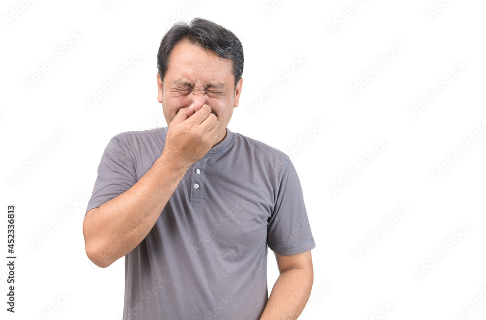 Man covers nose with hand, smells something awful Man covers nose with hand, smells something awful