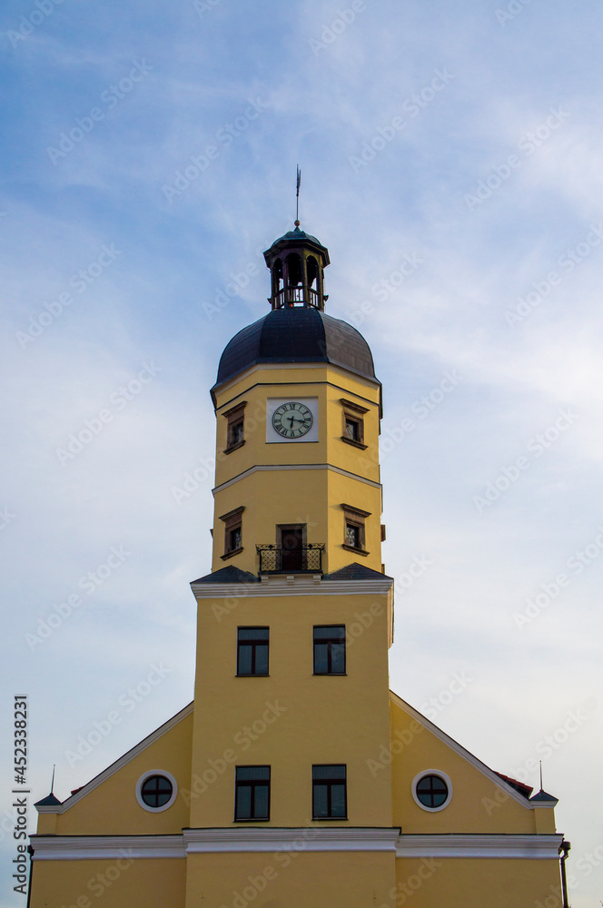 Old castle town hall tower at sunset