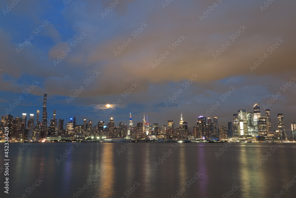 Beautiful Manhattan night view and moon seen from New Jersey