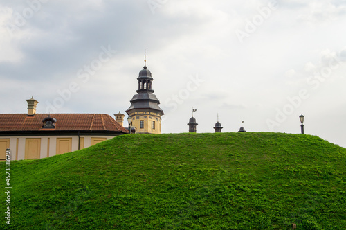 Green rampart hill near the ancient castle