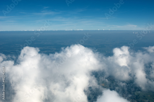Above view from plane on blue sky and clouds