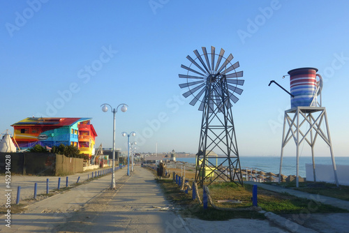 Empty footway in Vama Veche nonconformist resort on the Black Sea shore in Romania in early morning at the end of the summer season