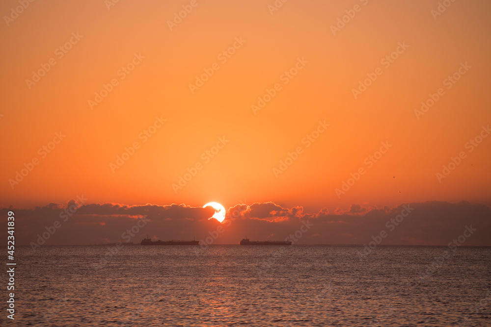 Sunrise at sea with ships