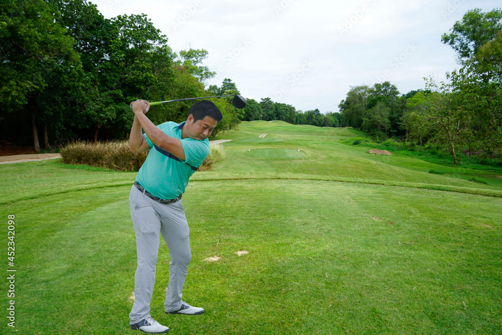 Golfer playing golf in the evening golf course on sun set evening time. Golfer playing golf in the evening golf course on sun set evening time.