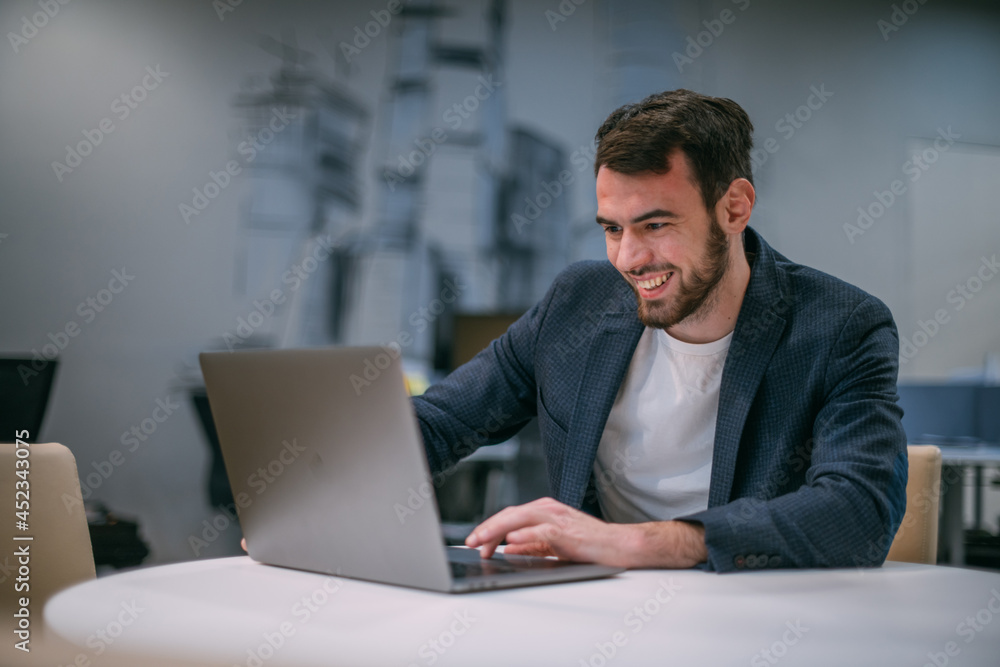 Portrait of contemporary young businessman at a working laptop Portrait of contemporary young businessman at a working laptop