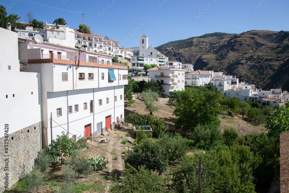 panorama of the town of the Alpujarra called Mecina Bombaron with white houses, church and mountains
