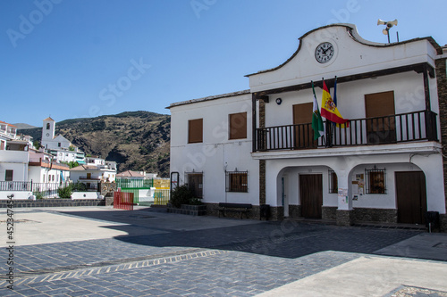 small town hall of Mecina Bombaron and with mountains and church in the background in the Alpujarra