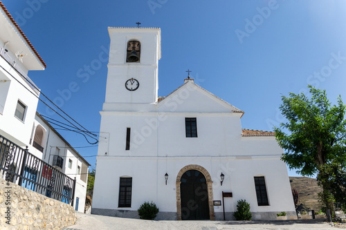 Parish Church of San Miguel archangel in Mecina Bombaron with a rectangular floor plan and a roof over semicircular gabled arches with Arabic tile and the portal is decorated with semicircular arches © Elena Fernández 