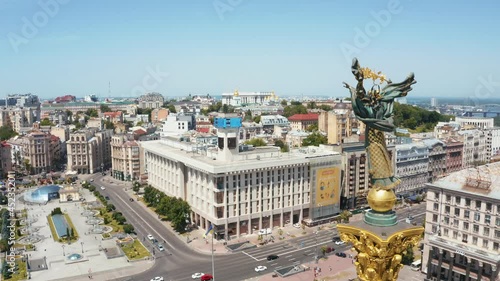 Aerial view of the Kyiv Ukraine above Maidan Nezalezhnosti Independence Monument. Golden beautiful Ukrainian woman statue in the middle of the city.  photo
