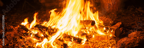 blurred campfire in the night. bonfire with a burning flame in the dark. banner
