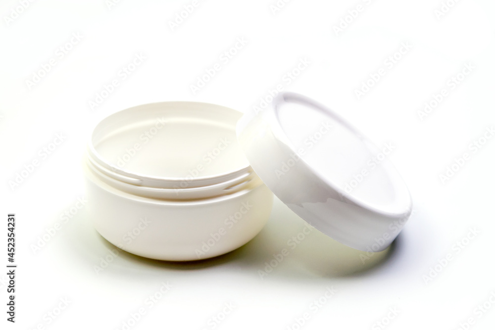 Empty White Plastic opaque cream jar with lid. Isolated on white background. Cosmetic product for skin care Empty White Plastic opaque cream jar with lid. Isolated on white background. Cosmetic product for skin care