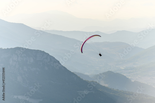 Paragliding flight in the air over the mountains.