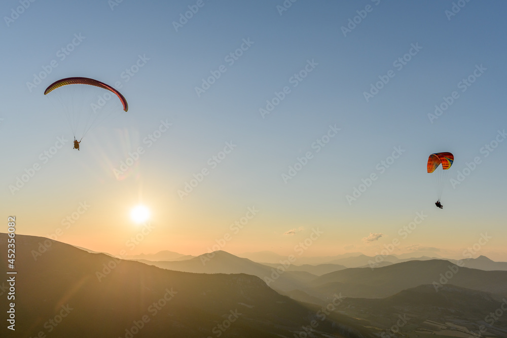 Paragliding flight in the air over the mountains. Paragliding flight in the air over the mountains.