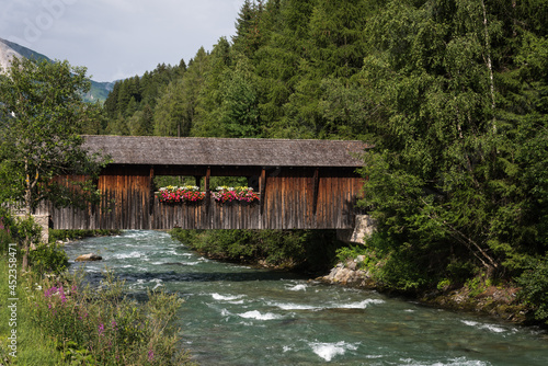 Wooden bridge crossing over Rosanna river, ski resort, St. Anton am Alberg, Vorarlberg, Austria