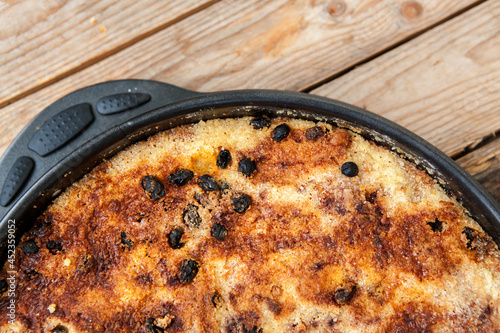 Just baked cake on wooden table 