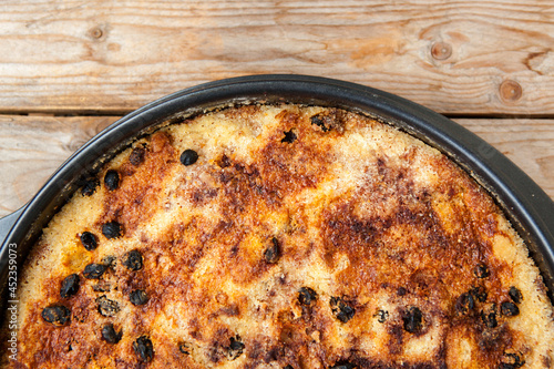 Just baked cake on wooden table 