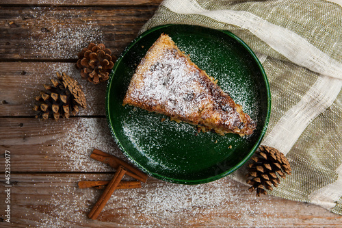 Tasty piece of pie on old wooden table