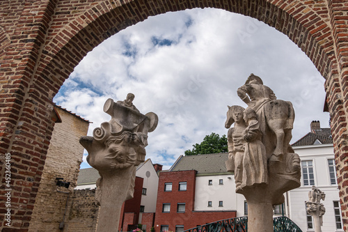 Gent, Flanders, Belgium - July 30, 2021: Looking over Brug der Keizerlijke Geneugten (Bridge of the emperors pleasures) over Lieve River, Zilverhof side statues. Houses on Sint Antoniuskaai.  photo