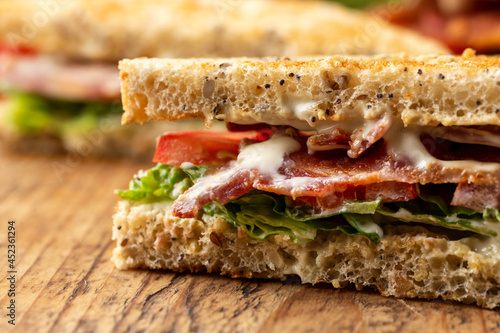 Fresh BLT Sandwich with Bacon Lettuce and Tomato on wooden board photo