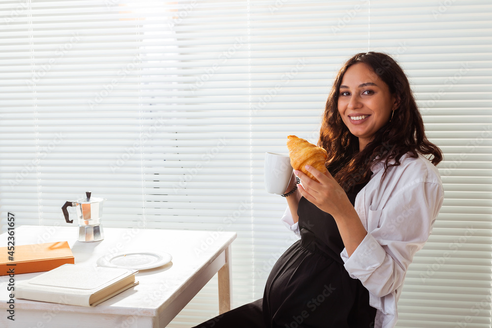 Pregnant woman eating breakfast. Pregnancy and maternity leave Pregnant woman eating breakfast. Pregnancy and maternity leave