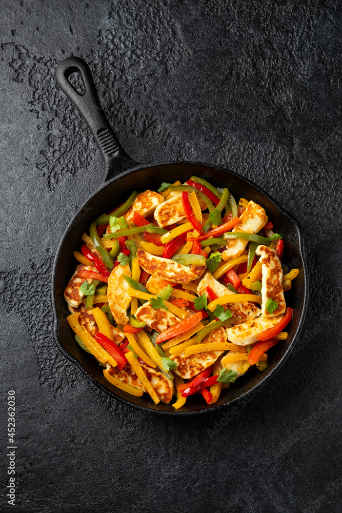 Tasty Halloumi cheese Fajitas with mix pepper in iron cast pan. Healthy food. Tasty Halloumi cheese Fajitas with mix pepper in iron cast pan. Healthy food.