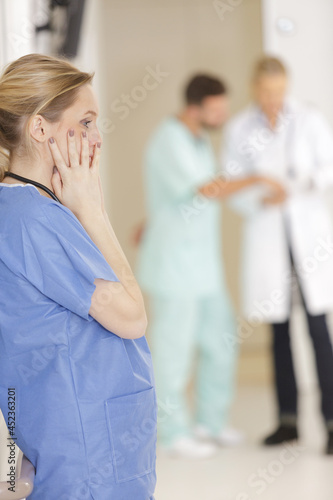 sad surgeon in corridor at hospital