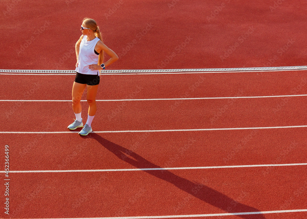 young woman in sports uniform stands at the stadium. sport exercise. healthy lifestyle young woman in sports uniform stands at the stadium. sport exercise. healthy lifestyle