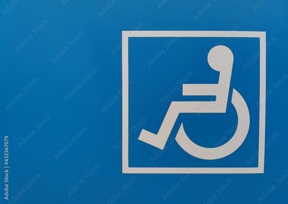 sign of a disabled person in a wheelchair on a bright blue background sign of a disabled person in a wheelchair on a bright blue background