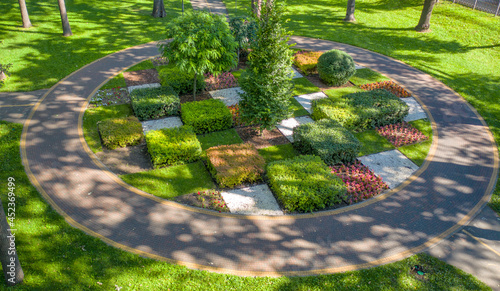 Obraz na plátně Topiary flower bed in the park, divided into square sections, aerial view