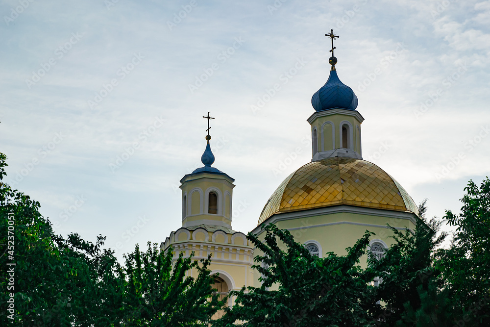 Golden and blue domes with crosses of a blue sky