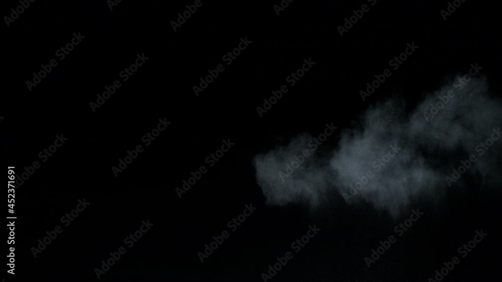 Misty chalk clouds blowing into the center. Isolated super slow motion white smoke and fog wisp on black background. Studio concept and VFX plate shot for scene overlay and creative enhancement. Misty chalk clouds blowing into the center. Isolated super slow motion white smoke and fog wisp on black background. Studio concept and VFX plate shot for scene overlay and creative enhancement.