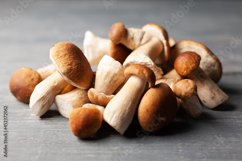 White or porcini mushrooms on wooden table.