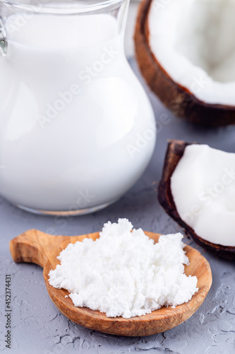 Coconut milk in powder and dissolved with water in a glass, lactose free milk, vertical