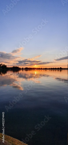 incredible sunset over a large lake. © Nazar